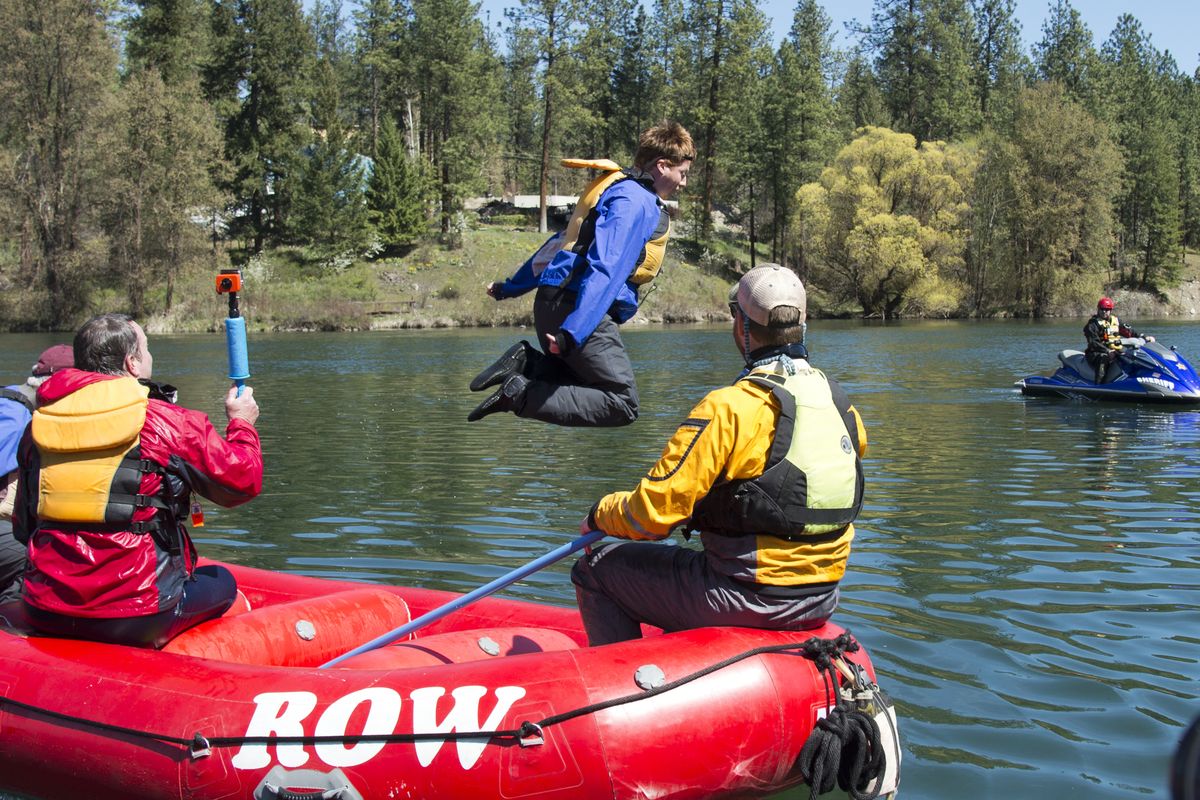 Freelance journalist Aaron Theisen leaps into the Spokane River to experience cold water immersion while on a raft trip Thursday. The trip, sponsored by Avista Utilities, was to demonstrate the dangers of cold water and being near the company’s dams. (Jesse Tinsley)