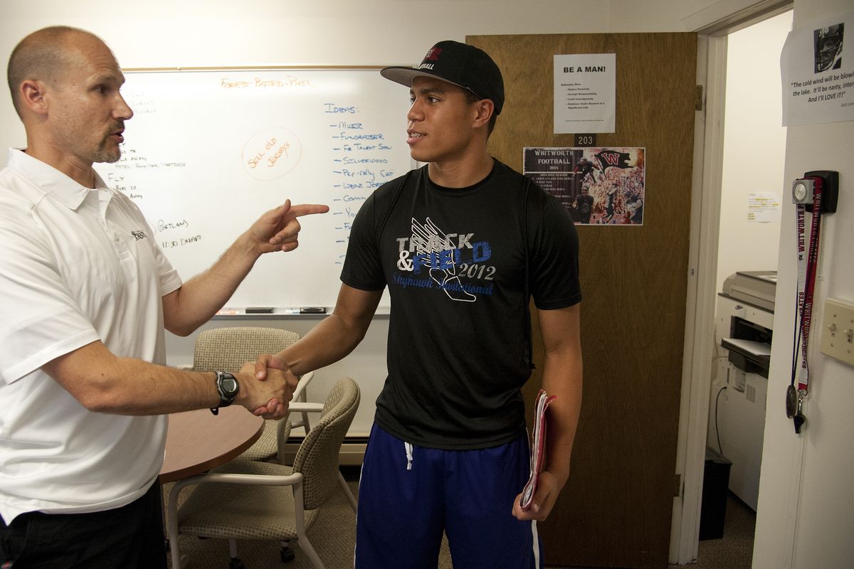 New Whitworth University football coach Rod Sandberg, who takes over for the departed John Tully, greets cornerback Jerrell Norman of Las Vegas back to campus. (Dan Pelle)