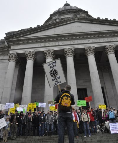 OLYMPIA -- Joe Korbuszewski, who works at Red Hot Beer Bar in Tacoma, addresses a rally against an increase in the tax on microbreweries Friday on the north Capitol steps. (Jim Camden)