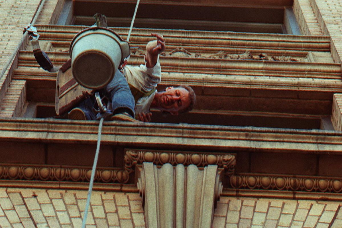Paul Gustafson, working for American Building Maintenance on July 22, 1994, cleans the  Great Western building at Riverside and Lincoln. (CHRIS ANDERSON / FILE/The Spokesman-Review)