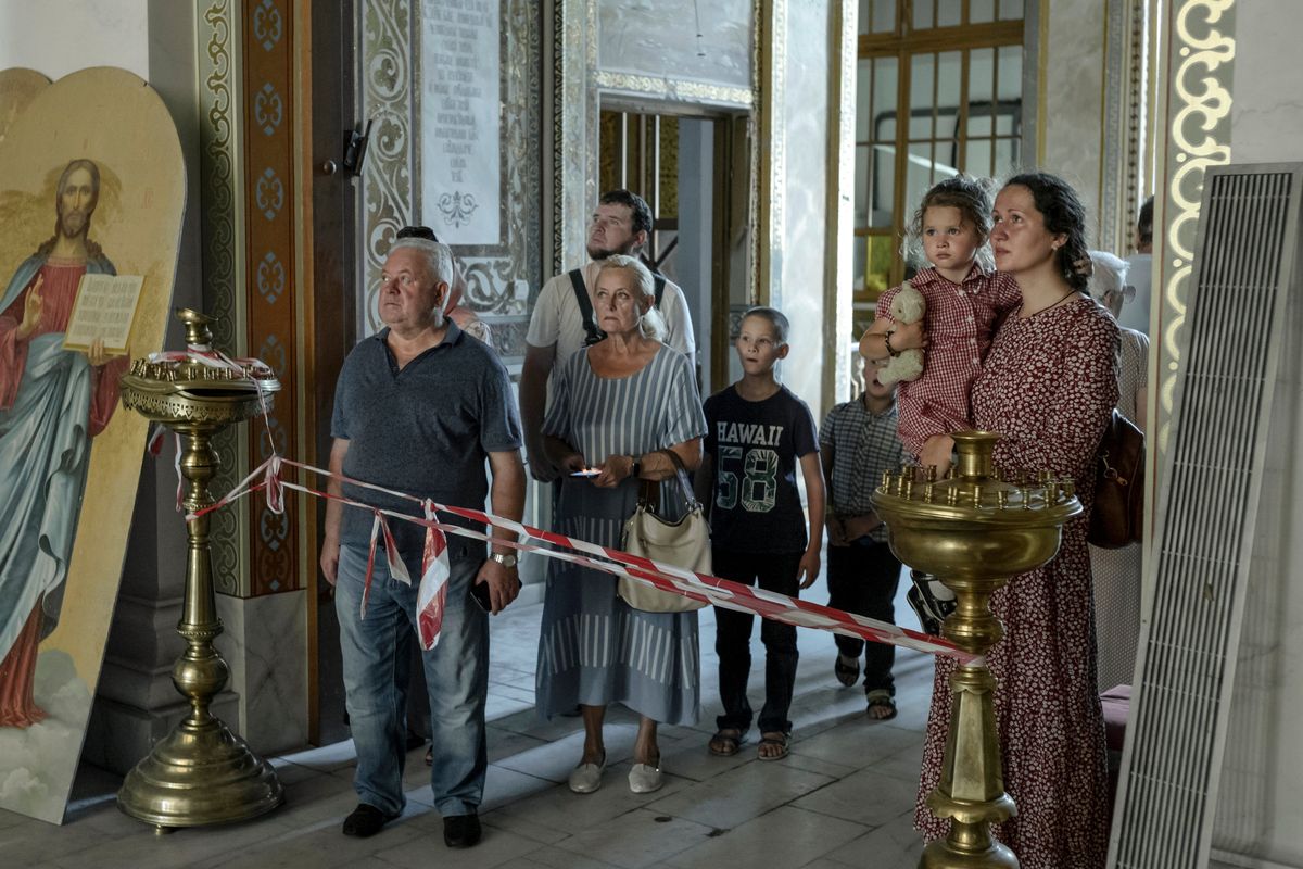 Residents viewing damage from Russian missiles inside the Odesa Transfiguration Cathedral in Odesa, Ukraine, on Tuesday. Russian bombardments have not only stiffened the will to resist, residents there said, but ratcheted up a sense of loathing for the invaders.  (EMILE DUCKE)