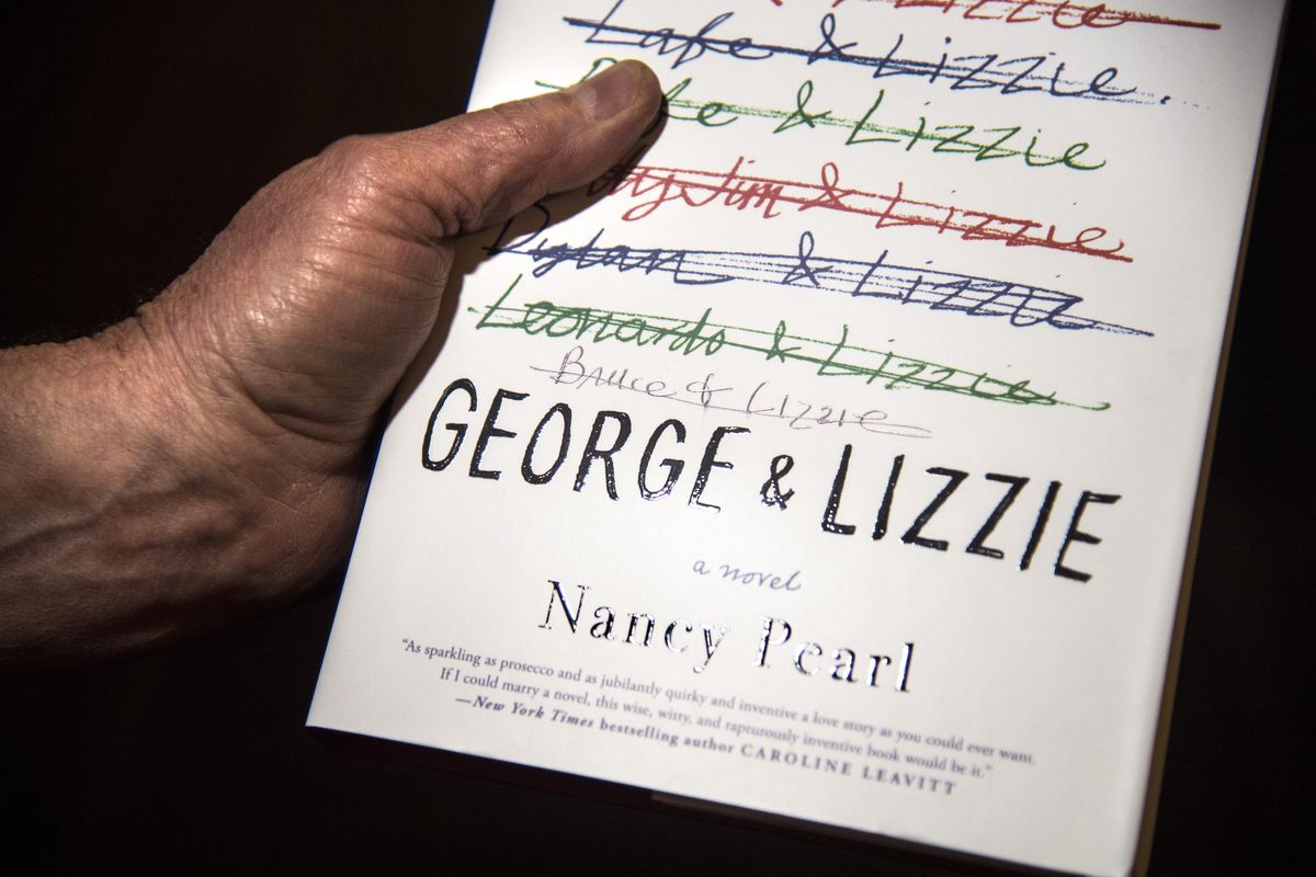 Bruce Andre has his copy of Nancy Pearl’s “George & Lizzie” customized by the author, during the Northwest Passages Book Club event, Saturday, Jan. 20, 2018. (Dan Pelle / The Spokesman-Review)