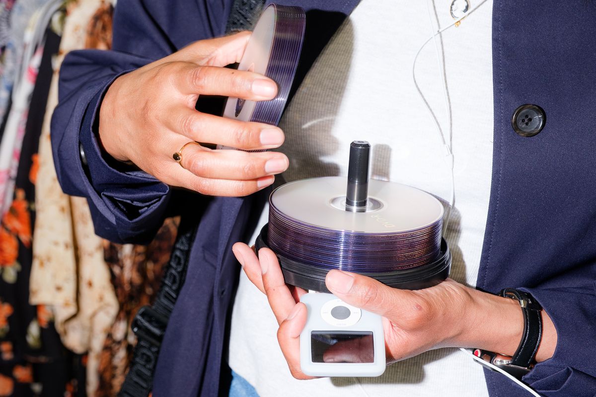 Angeline Richard listens to her iPod while thrifting in Raleigh, N.C., on Feb. 2. It’s not exactly going analog, but people looking to move away from streaming say Apple’s old device is a small step away from constantly being online.  (New York Times)
