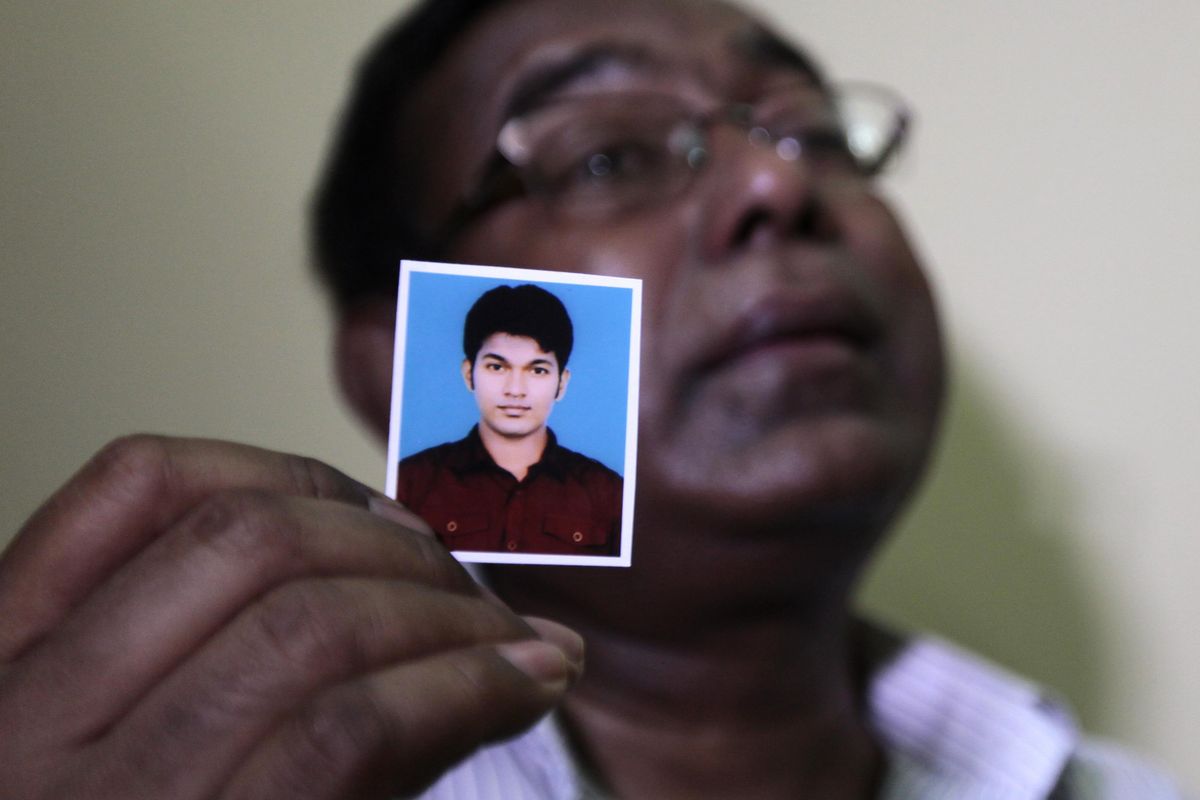 Bangladeshi Quazi Ahsanullah displays a photograph of his son Quazi Mohammad Rezwanul Ahsan Nafis as he weeps in his home in the Jatrabari neighborhood in north Dhaka, Bangladesh, Thursday, Oct. 18, 2012. The FBI arrested 21-year-old Nafis on Wednesday after he tried to detonate a fake 1,000-pound (454-kilogram) car bomb, according to a criminal complaint. His family said Thursday that Nafis was incapable of such actions. (A.m.ahad A.m.ahad / Associated Press)
