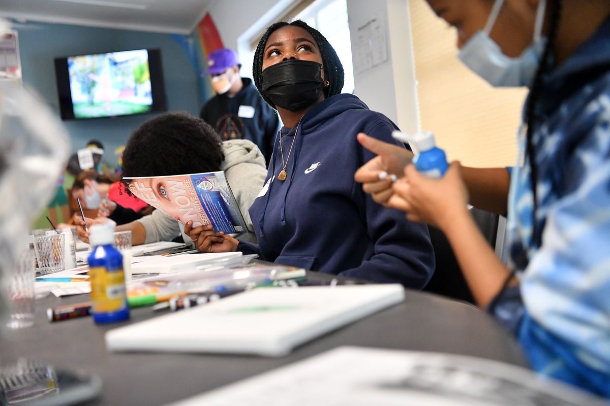 Daejae Williams, 13, listens to pointers Saturday as she begins working on a painting during a Youth Empowerment Program Art and Storytelling Clinic at The Way to Justice in Spokane. (Tyler Tjomsland/The Spokesman-Review)