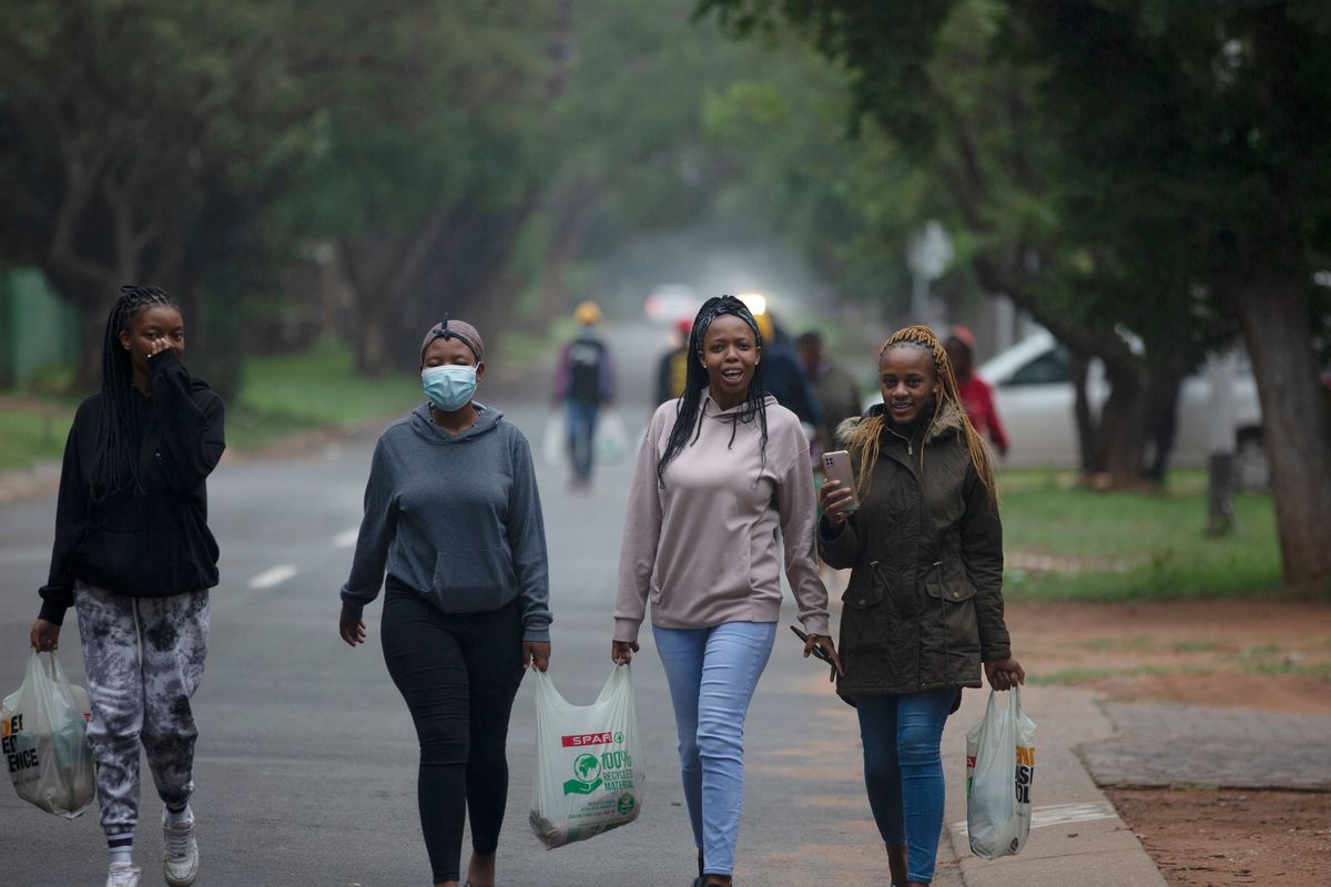Students from the Tshwane University of Technology make their way back to their residence in Pretoria, South Africa, Saturday.  (Denis Farrell)