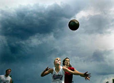 As storm clouds start to gather over downtown Megan Pittman, front, battles Molly Leach in the coed family division. At left, is Ross Pittman.
(Christopher Anderson/ / The Spokesman-Review)