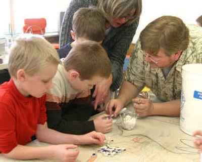 
Lawrence Adrian, the artistic airector for the Oregon Coast Children's Theatre and Youth Art Center, demonstrates to the second- and third-grade boys of Canyon Elementry School how to apply tile and lay down glue.
 (Barbara Minton / The Spokesman-Review)
