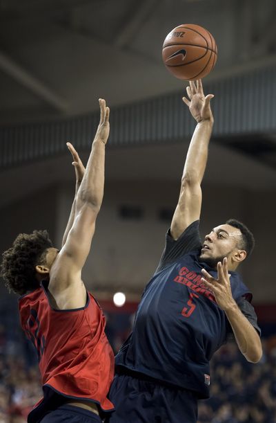 Nigel Williams-Goss, right, shooting over Jeremy Jones during the Kraziness in the Kennel scrimmage last month, will make his debut in a GU uniform Saturday but Jones will not because of a high ankle sprain. (Colin Mulvany / The Spokesman-Review)