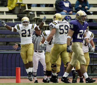 
UCLA tailback Maurice Drew (21) celebrates one of his five touchdowns against Washington as center Mike McCloskey (59) comes in to join him. 
 (Associated Press / The Spokesman-Review)