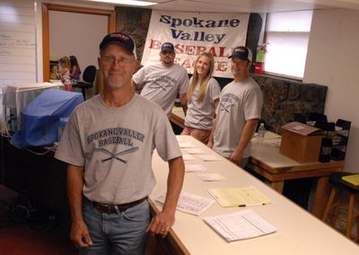 Bill Kreider has taken over the helm of the Spokane Valley Baseball League with the help of his son Chris, back left, daughter-in-law Sarah, middle, and Cory Aitken.  The group’s new offices are located in the basement of Tom’s Barber Shop, just off Bowdish Road and Sprague Avenue. (J. BART RAYNIAK / The Spokesman-Review)
