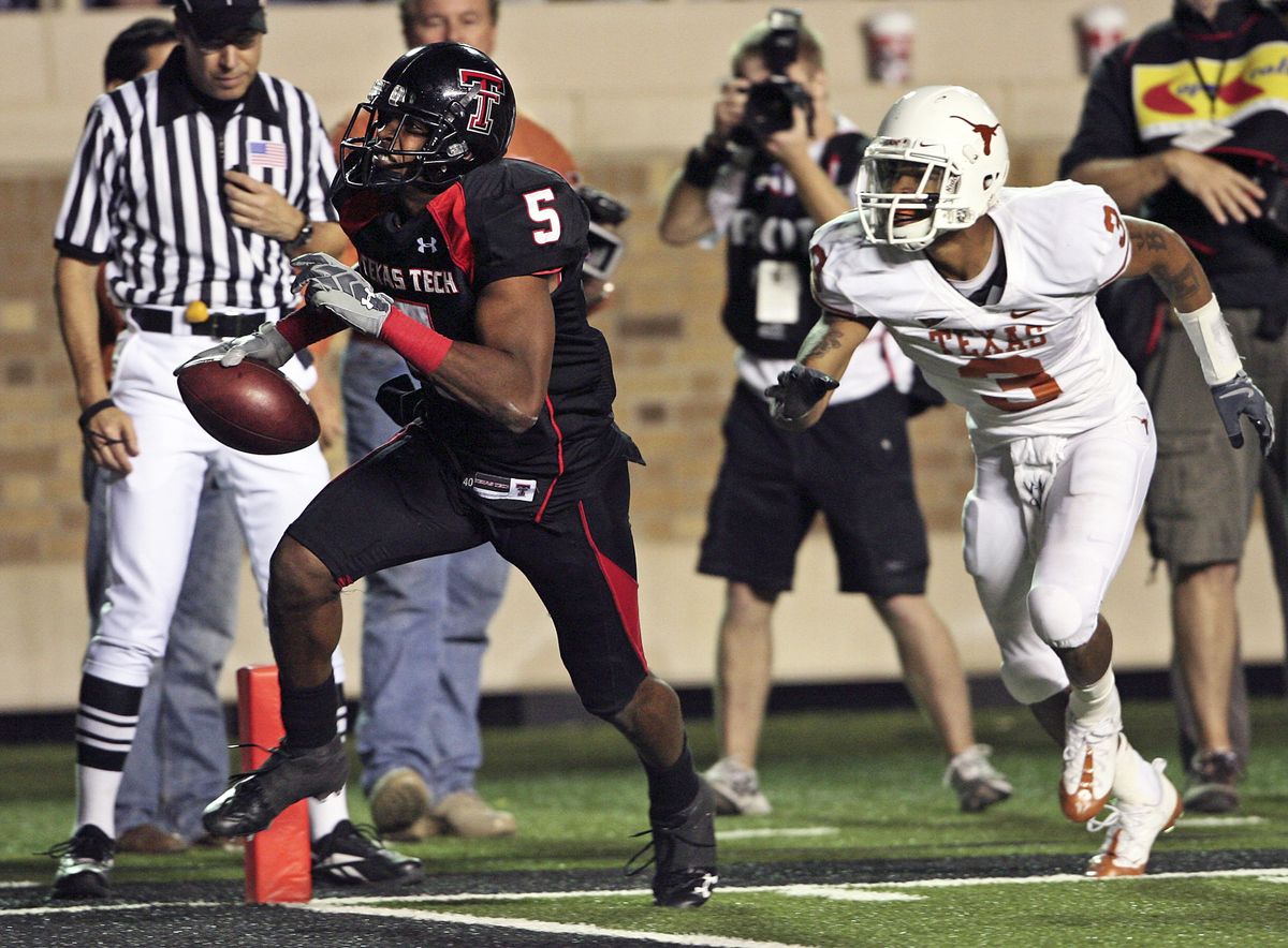 Texas Tech receiver Michael Crabtree strides past Texas’ Curtis Brown and into the end zone with the winning score.  (Associated Press / The Spokesman-Review)