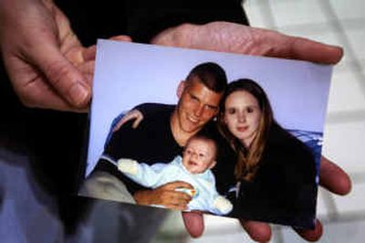 
Sarah Miller holds a photo of her husband, Harley Miller, 21, herself and their son, Korey, now almost 1 1/2  years old. Harley Miller was killed in a plane crash in Afghanistan. 
 (Jed Conklin / The Spokesman-Review)