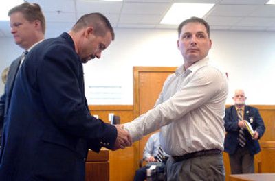 
Mark Arnold Crawford stares at his family as he is handcuffed by a bailiff. 
 (Jesse Tinsley / The Spokesman-Review)