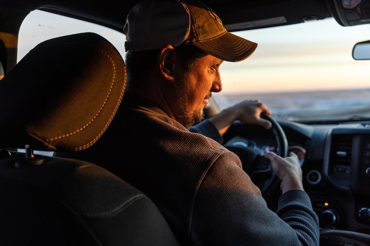 Scott Heidebrink, director of bison restoration for the American Prairie, a nonprofit conservation group, on an early-morning bison check, near Malta, in northeast Montana, Nov. 30, 2022. A long-term project to rebuild the prairie