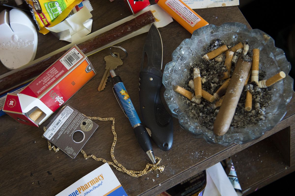 A knife, cigarettes and snacks are seen Tuesday in the room where Aaron D. Johnson was staying at the West Wynn Motel  in Spokane. Johnson, who has schizophrenia, was shot eight times in a confrontation with Spokane police in 2014. He was shot again Monday at a motel in west Spokane. (Tyler Tjomsland / The Spokesman-Review)