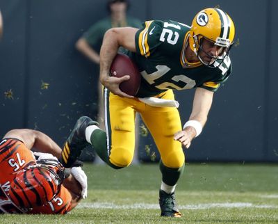 In this Sunday, Sept. 24, 2017, file photo, Green Bay Packers’ Aaron Rodgers tries to get away from Cincinnati Bengals’ Jordan Willis during the first half of an NFL football game in Green Bay, Wis. The Chicago Bears and Green Bay Packers will renew the NFLs oldest rivalry when they meet on Thursday night at Lambeau Field. (Mike Roemer / Associated Press)