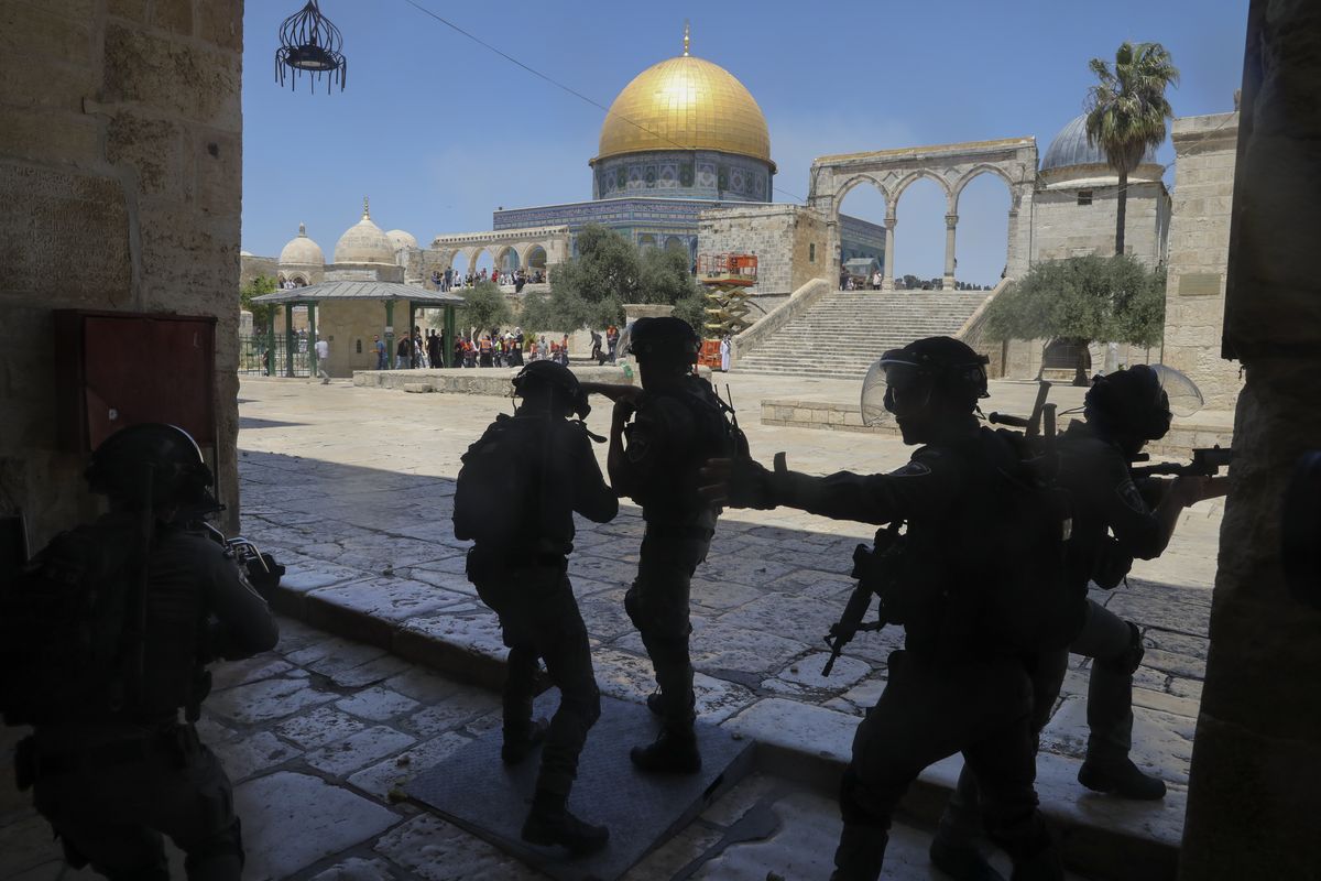 FILE - In this June 18, 2021, file photo, Israeli security forces take positions during clashes with Palestinians in front of the Dome of the Rock Mosque at the Al Aqsa Mosque compound in Jerusalem