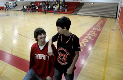 Sandpoint High School basketball player Tony Locascio, left, is pictured  with his little brother, Daniel, at the high school on Dec. 17. Tony Locascio is a volunteer coach for fifth- and sixth-grade basketball teams. Daniel is one of the players on the team. (Kathy Plonka / The Spokesman-Review)