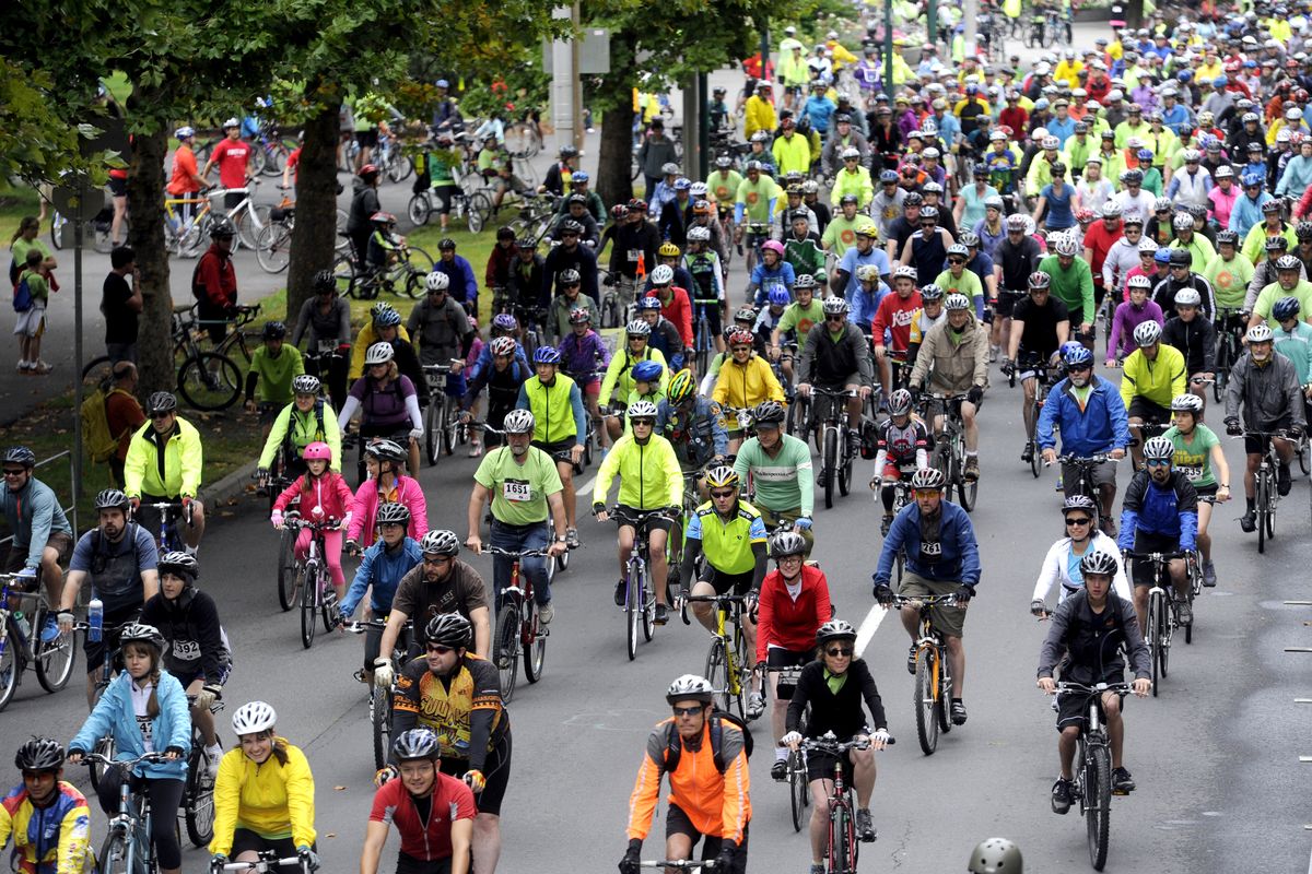 Hundreds of cyclists begin to move down Spokane Falls Boulevard for the 21-mile road ride at SpokeFest on Sunday. Cyclists could take part in rides of varying lengths and children could ride a 1-mile loop at Riverfront Park. (Jesse Tinsley)