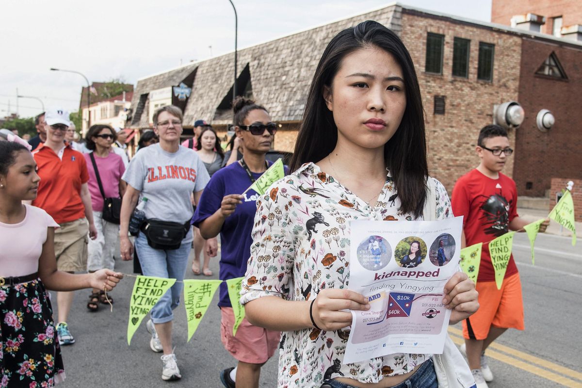 Fangqin Wan, a graduate student at the University of Illinois, walks for Yingying Zhang, a Chinese scholar who went missing three weeks ago, Thursday, June 29, 2017, in Urbana, Ill. Illinois students and others from the wider community are gathering at the Urbana-Champaign campus to show support for the Chinese scholar who disappeared three weeks ago. (Holly Hart / AP)