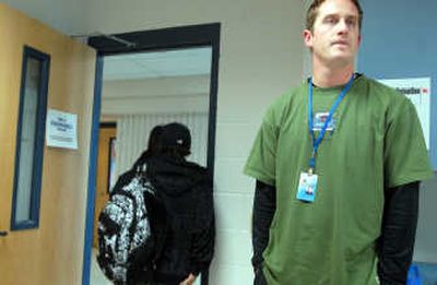 
Corey Comstock watches students leave the daily lunch detention session he oversees at Coeur d'Alene High School   in October. Comstock monitors in-school suspension and detention, sometimes the result of students using foul language. 
 (Jesse Tinsley / The Spokesman-Review)