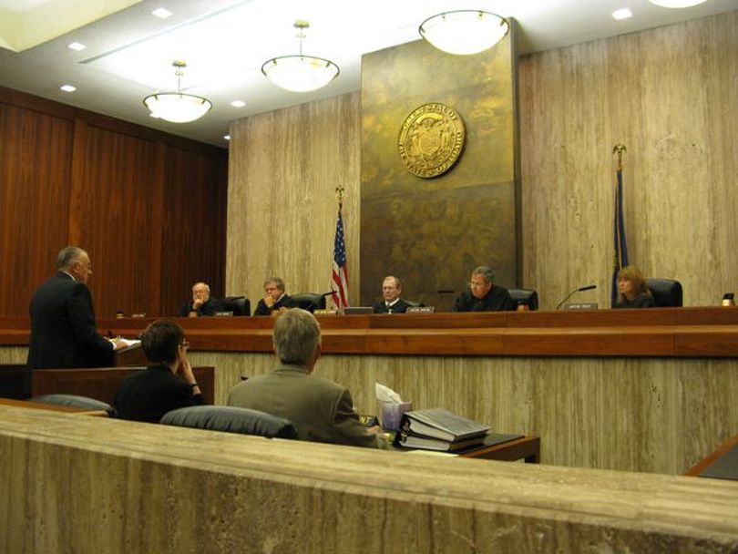 Idaho Supreme Court justices question Merlyn Clark, the private attorney representing the Idaho State Land Board on Wednesday, during arguments in a lawsuit brought against the board by Idaho Attorney General Lawrence Wasden over rents for state-owned cabin sites. (Betsy Russell)