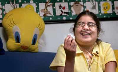 Isabel Bermeo, 14, shows off a Secret Service coin given to her by an agent after she met President Bush last week. Bermeo suffers from cystic fibrosis and currently lives at the Ronald McDonald House in Spokane while she waits for a lung transplant. Below, Isabel Bermeo and her mother, also named Isabel Bermeo, met President Bush last week.
(The Spokesman-Review)