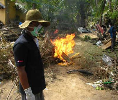 
Bodies of tsunami victims are  cremated by a clearance squad at work on Sri Lanka's Navaladi penninsula. Some corpses are being buried where they are found. 
 (Casey Johnson/Special to / The Spokesman-Review)