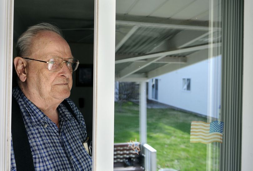 Don Bain can keep an eye on his detached shop (reflected in sliding door) from his back porch in Spokane Valley, Wash.,  where he says squatters have moved into the shop and refuse to leave.  4/15/09  DAN PELLE The Spokesman-Review (Dan Pelle / The Spokesman-Review)