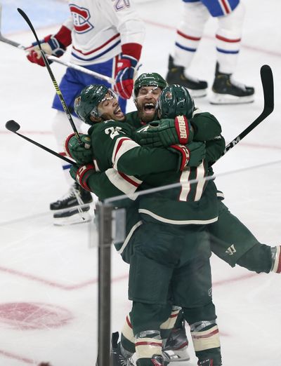 Minnesota Wild's Zach Parise, right, celebrates with teammates Jason Zucker, center, and Matt Dumba, right, after scoring a goal against the Montreal Canadiens in the third period of an NHL hockey game Sunday Oct. 20, 2019, in St. Paul, Minn. (Stacy Bengs / Associated Press)