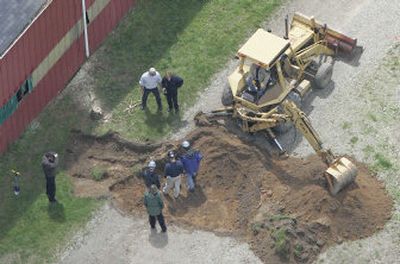 
Unidentified workers dig near a barn at a horse farm Thursday in Milford Township, Mich., where FBI agents acting on a tip are investigating Teamster leader Jimmy Hoffa's 1975 disappearance. 
 (Associated Press / The Spokesman-Review)