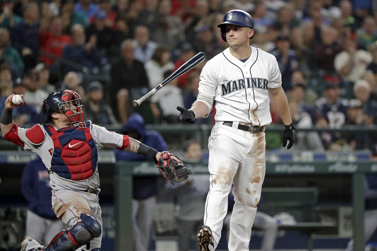Seattle’s Kyle Seager flips his bat after striking out swinging as Boston Red Sox catcher Christian Vazquez returns the ball to the pitcher during the seventh inning Thursday in Seattle. (Elaine Thompson / AP)