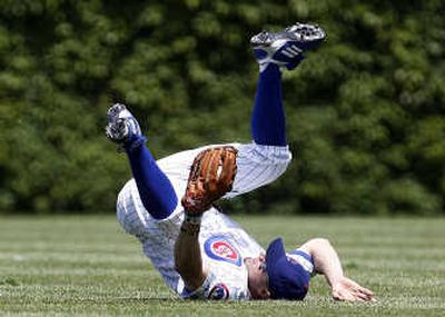 
Associated Press Chicago Cubs center fielder Reed Johnson dives to catch a fly ball hit by Colorado Rockies' Chris Iannetta on Saturday.
 (Associated Press / The Spokesman-Review)