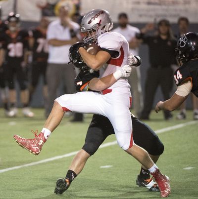 Ferris' James Mann runs into a Lewis and Clark brick wall named Nicklaus Nystrom in the first quarter, Sept. 25, 2015, at Albi Stadium. (Dan Pelle / The Spokesman-Review)