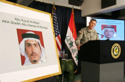 
Military spokesman Maj. Gen. William Caldwell IV looks at a photo of Abu Ayyub Masri, who is allegedly the new al-Qaida in Iraq leader, during a news conference Thursday in Baghdad, Iraq. 
 (Associated Press / The Spokesman-Review)