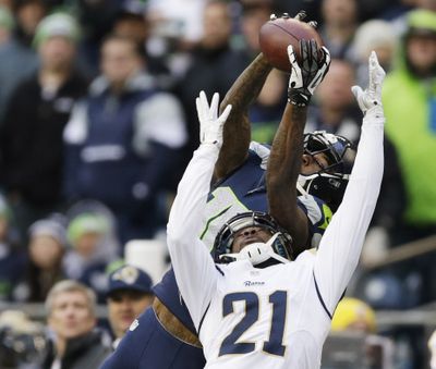 Seahawks wide receiver Paul Richardson, top, makes a leaping reception against the defense of St. Louis Rams' Janoris Jenkins. (Associated Press)