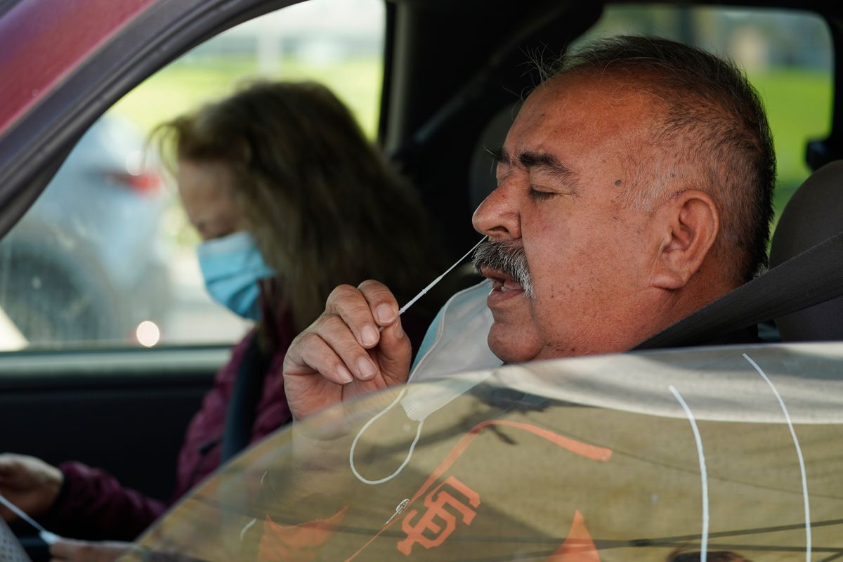 Jose Alfrtedo De la Cruz and his wife, Rogelia, self-test for COVID-19 on Tuesday at a No Cost COVID-19 Drive-Through event provided by the GUARDaHEART Foundation for the City of Whittier community and the surrounding areas at the Guirado Park in Whittier, Calif.  (Damian Dovarganes)