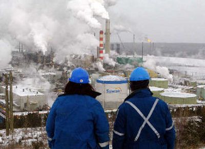 Workers overlook the processing plant at the Suncor tar sands project in Ft. McMurray, Alberta.
(Canadian Press / The Spokesman-Review)