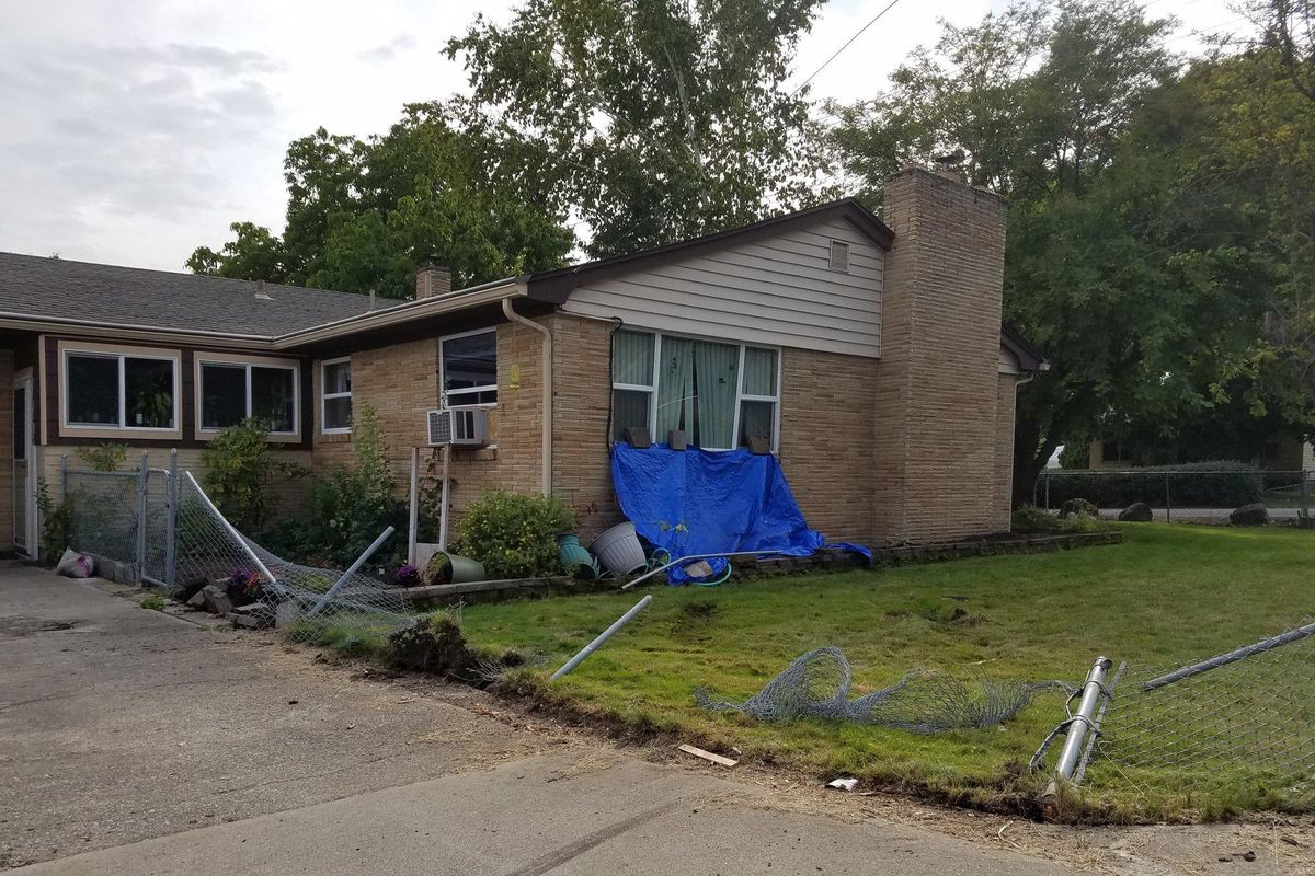 Kris Redmond’s home was hit by an SUV Friday afternoon after the driver drover over a boulder, a chain link fence into the cinderbock walls. (Rebecca White / The Spokesman-Review)