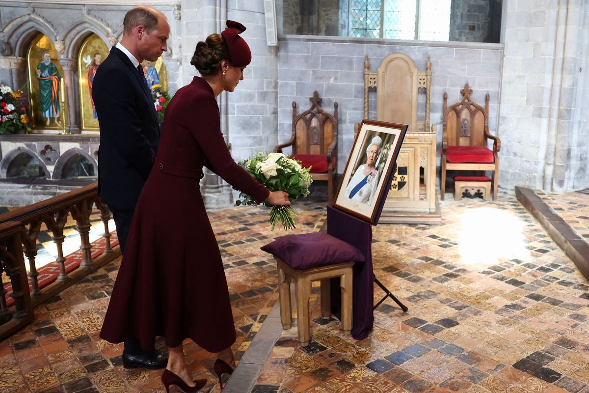 Britain’s Prince William, Prince of Wales and Britain’s Catherine, Princess of Wales lay flowers during a visit St David’s Cathedral in southwest Wales on Friday to commemorate the life of Her Late Majesty Queen Elizabeth II on the first anniversary of her passing.  (Toby Melville/Pool/AFP/Getty Images North America/TNS)