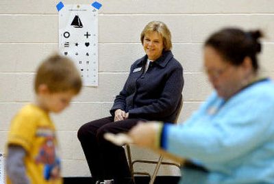 
School nurse Cindy Perry, center, helps conduct vision screening at Atlas Elementary in Coeur d'Alene. 
 (Kathy Plonka / The Spokesman-Review)