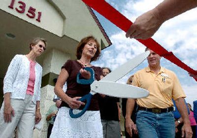 
Principal Ann Walker prepares to cut the ribbon on the remodeled Ramsey Elementary in Coeur d'Alene on Tuesday while school board Chairman Vern Newby, right, and trustee Diane Zipperer, left, watch. 
 (The Spokesman-Review)