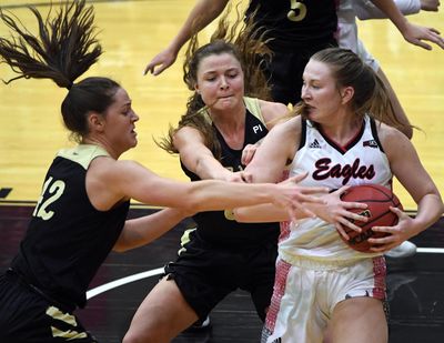 Idaho’s Natalie Klinker, left, and Lizzy Klinker, center, give Eastern Washington’s Grace Kirscher a taste of defense honed in Montana. (Colin Mulvany / The Spokesman-Review)