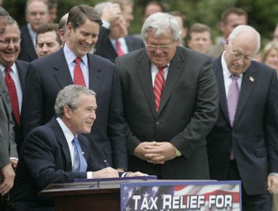 
President Bush signs the Tax Relief Extension Reconciliation Act into law Wednesday, joined by, from left, Sen. Mitch McConnell, R-Ky.; Sen. Bill Frist, R-Tenn.; Rep. Dennis Hastert, R- Ill.; and Vice President Dick Cheney. 
 (Associated Press / The Spokesman-Review)