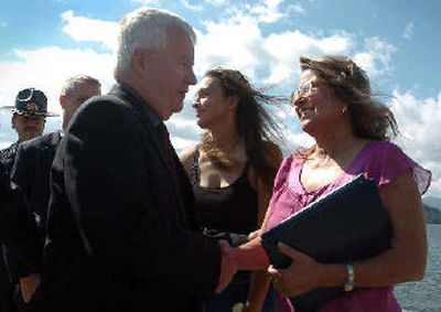 
U.S. Attorney Tom Moss congratulates  heroes Linda C. Olson, right, and Amber Deahn, after they received their awards on Thursday. 
 (Jesse Tinsley / The Spokesman-Review)