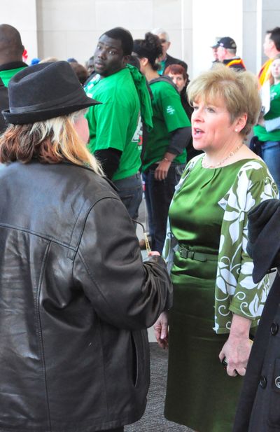 Sen. Lisa Brown discusses tax exemptions, and the difficulty in repealing any of them, with protester Debbie Sills at Friday's labor rally at the state Capitol. (Jim Camden/The Spokesman-Review)