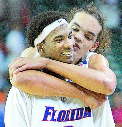 
Florida's Joakim Noah congratulates Corey Brewer after his 19-point game. 
 (Associated Press / The Spokesman-Review)