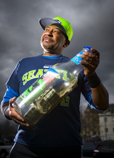 Gene Aikens found success quitting smoking by putting the money he would have bought cigarettes with into a bottle bank. Aikens is the newest face of the health district's Done My Way antismoking campaign. (Colin Mulvany / The Spokesman-Review)