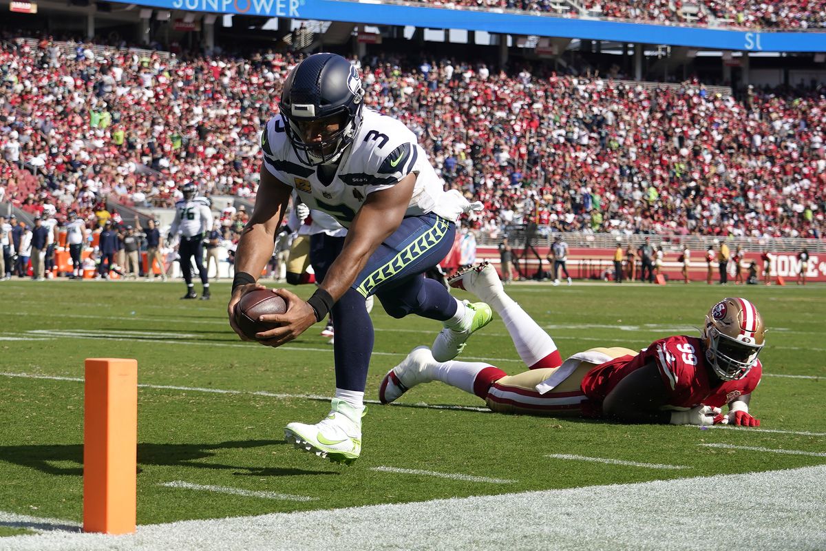 Seattle Seahawks quarterback Russell Wilson (3) runs for a touchdown past San Francisco 49ers defensive tackle Javon Kinlaw (99) during the second half of an NFL football game in Santa Clara, Calif., Sunday, Oct. 3, 2021.  (Associated Press)
